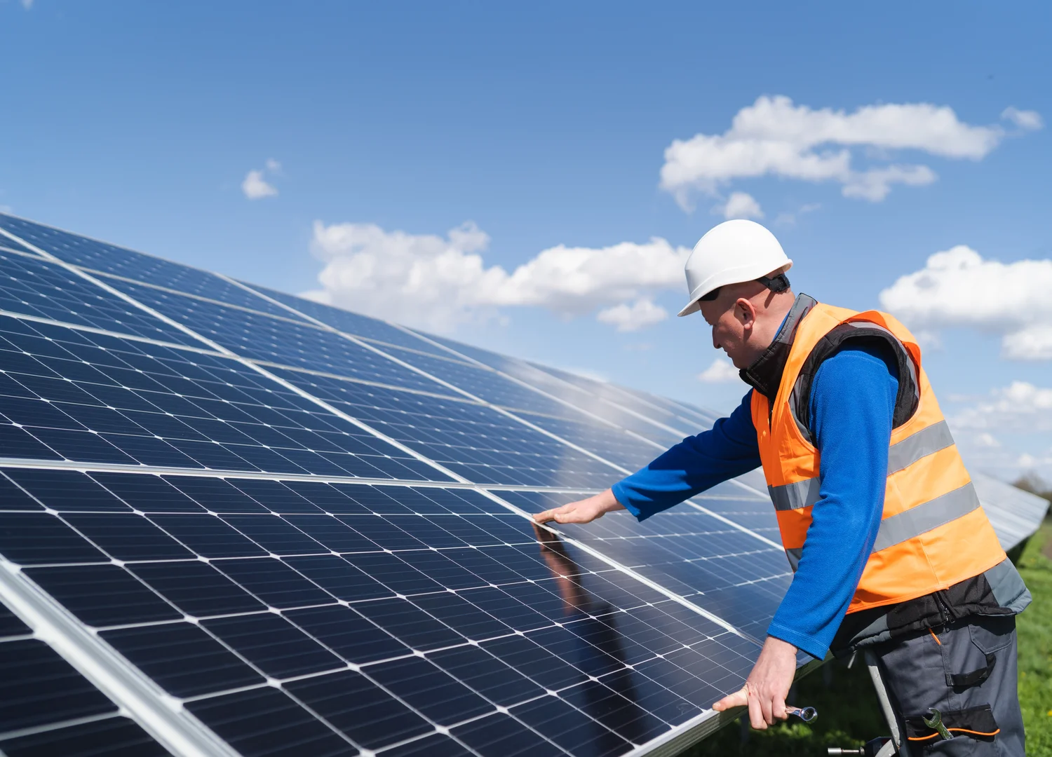 Maintenance technician performing a visual inspection on a solar plant panel