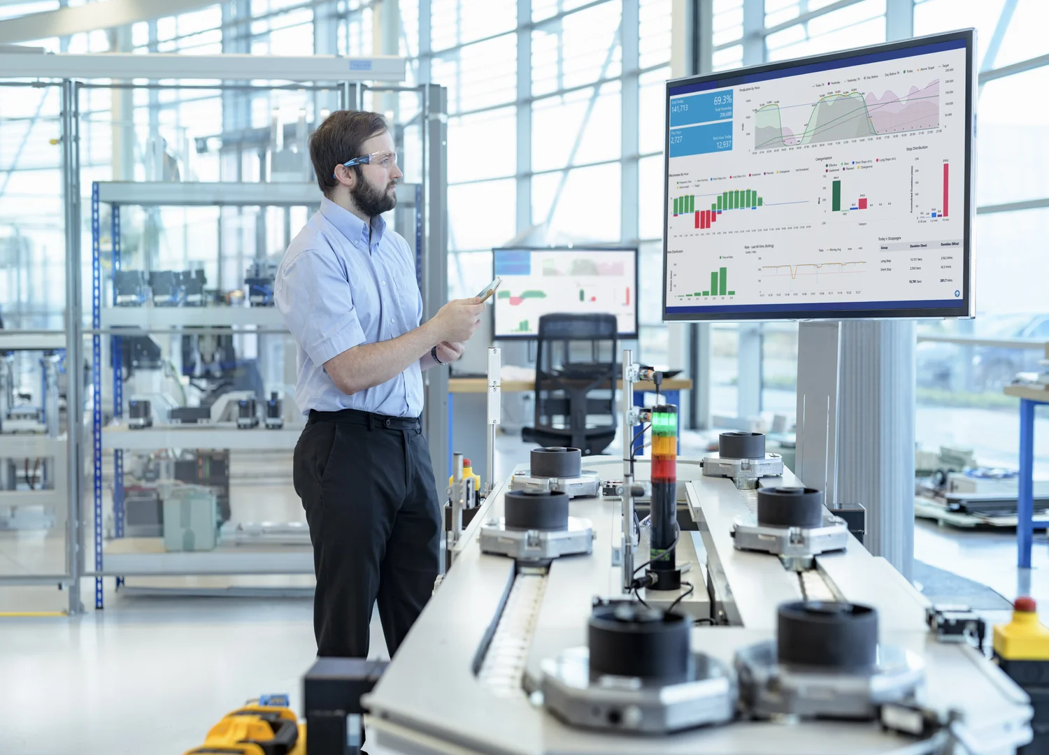 Maintenance engineer checking data from different company areas