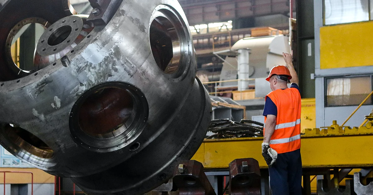 Man performing corrective maintenance on an industrial asset